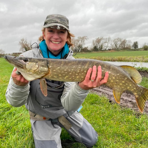 woman holding up fish