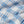 Load image into Gallery viewer, A close-up of a plaid fabric with a white base, blue stripes, and thin orange and gray lines forming a checkered pattern.
