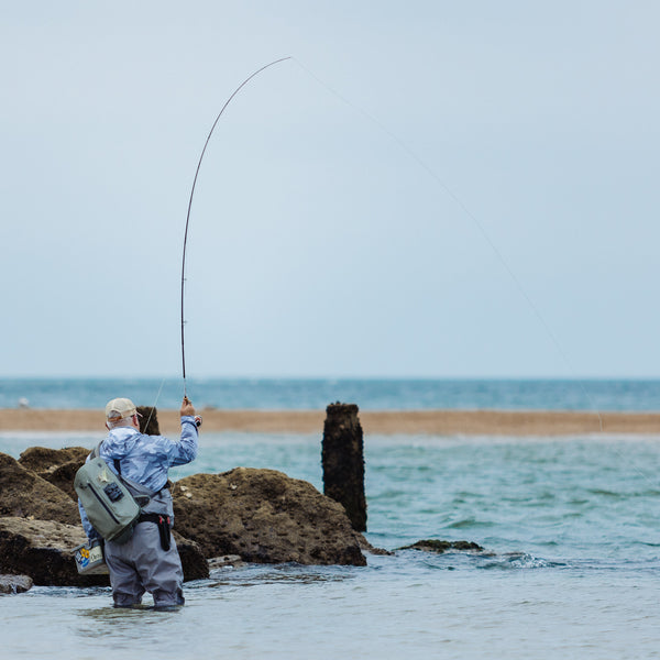 man wading on river side