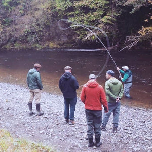 Group of men fly fishing