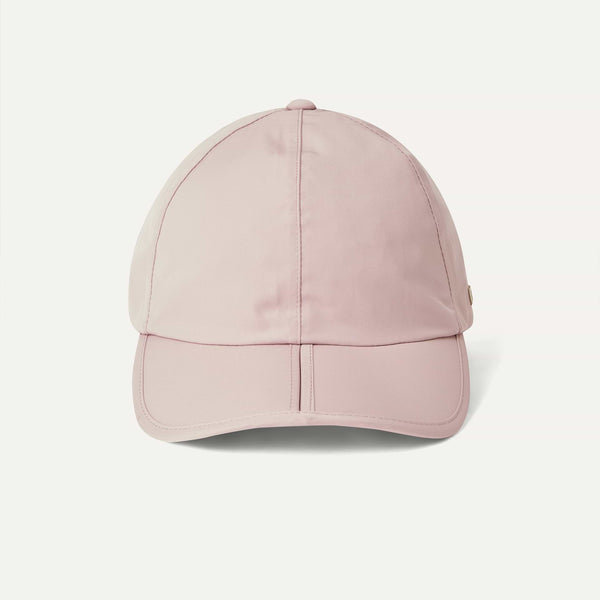Pink baseball cap on a light gray background