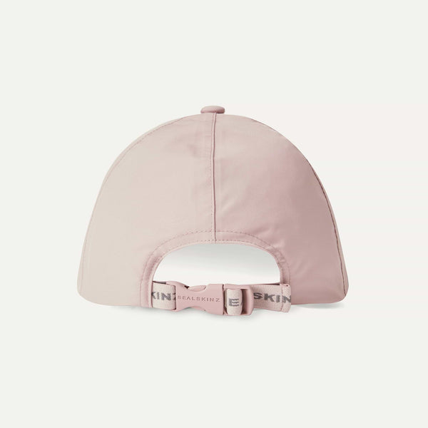 Pink cap with a brand logo on a light gray background