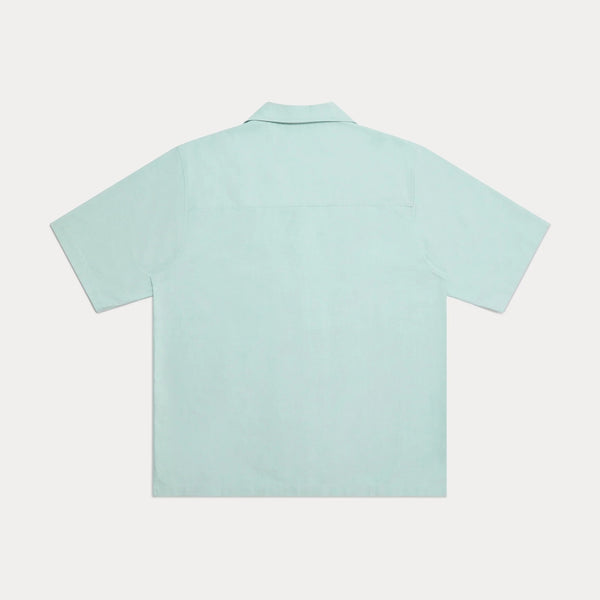 backside of light green short sleeved shirt on white background