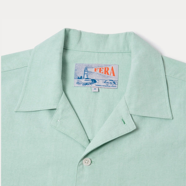 closeup of light green collar on shirt on white background