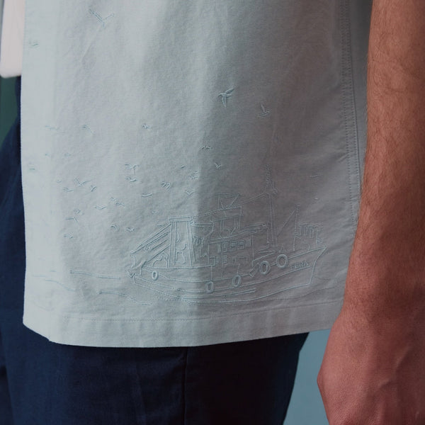 closeup og details on light green shirt