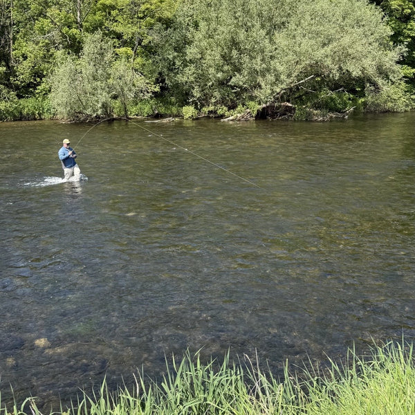 man fly fishing in river