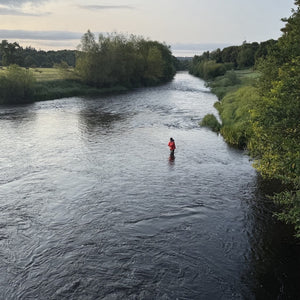 pereson fly fishing in river