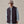 Load image into Gallery viewer, Person wearing a dark vest over a light blue shirt with a beige cap on a plain background
