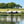 Load image into Gallery viewer, house next to lake with green fields in the background
