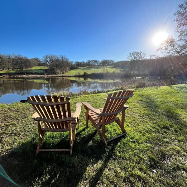 tow chairs facing the lake on a sunny day