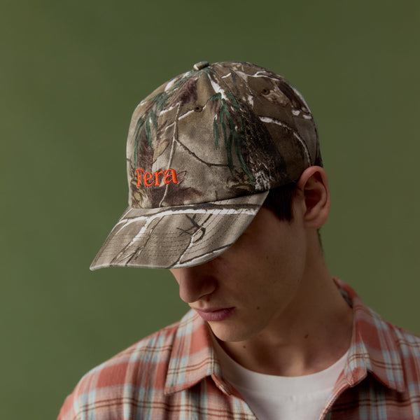 man looking fown wearing camouflage cap from Fera