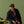 Load image into Gallery viewer, Person sitting on a yellow motorcycle against a green background
