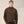 Load image into Gallery viewer, A man wearing a dark brown corduroy jacket with a high stand-up collar and matching brown pants, standing against a light beige fabric backdrop.

