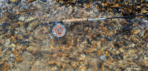 fly rod layed underwater on river bed