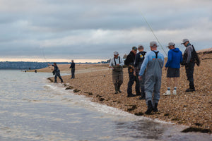 people on riverbed fly fishing