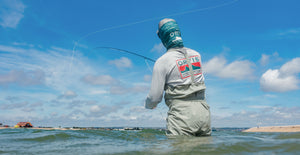 man wading wearing orvis longsleeved tshirt and bib