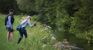 People fly-fishing at Kimbridge beat on the River Test.