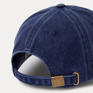Navy blue baseball cap with a gold buckle on a light gray background
