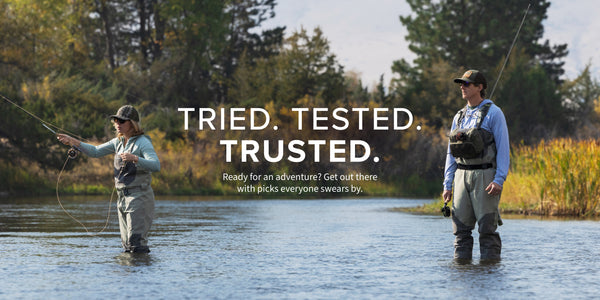Two people fly fishing in a river with text overlay 'Tried. Tested. Trusted.'