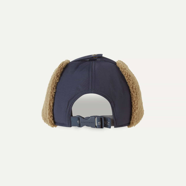 Navy blue cap with brown ear flaps on a light gray background