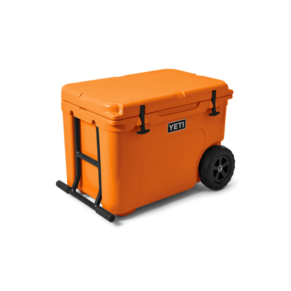 Orange YETI cooler with wheels on a white background