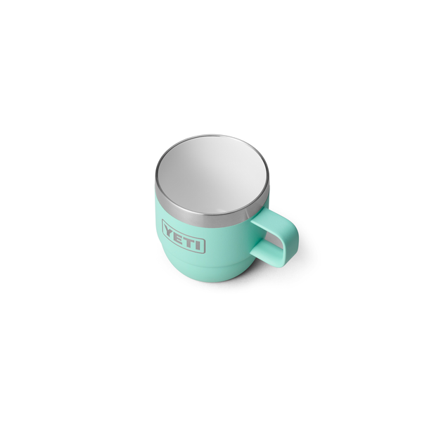 Turquoise YETI mug with silver lid on a white background