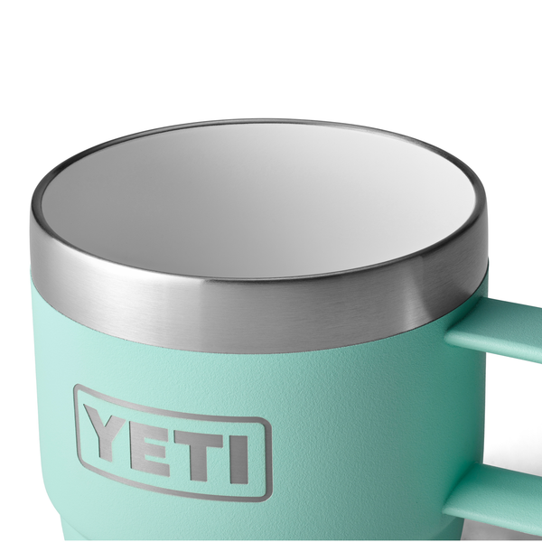 Teal YETI mug with a silver rim on a white background
