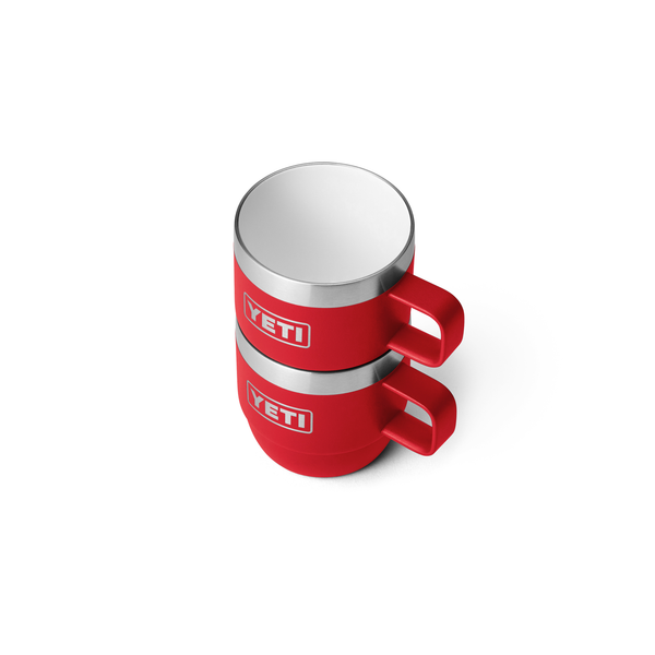 Two red YETI mugs stacked on a white background