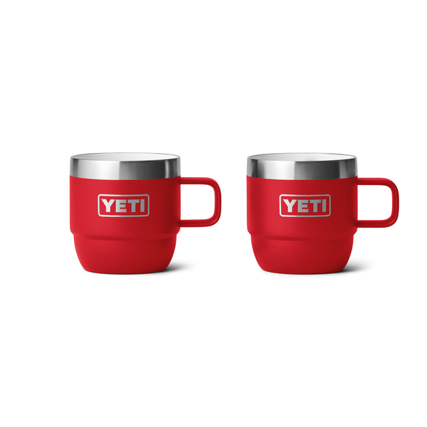 Two red YETI mugs with silver rims on a white background