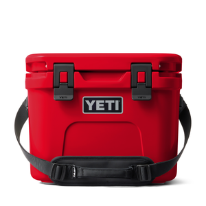 Red YETI cooler with black straps on a white background