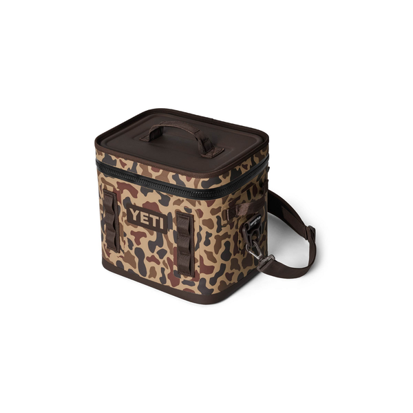 Camouflage-patterned cooler bag with 'YETI' logo on a white background