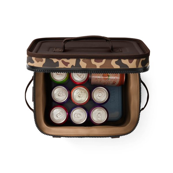 Camouflage-patterned Yeti cooler bag with drinks on a white background