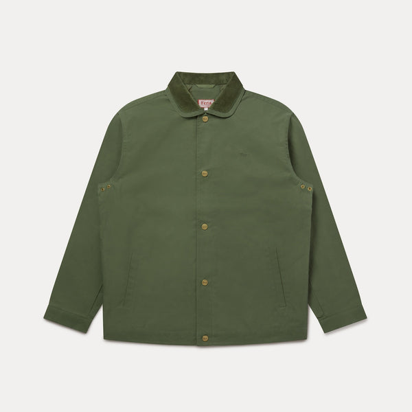 An olive green canvas jacket with a contrasting dark green corduroy collar and brass buttons, displayed flat against a light gray background.