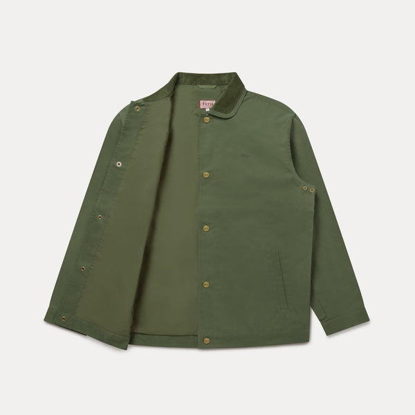 An olive green utility jacket with a button-up front, snap details on the sleeves, and a corduroy collar, displayed flat against a light gray background.