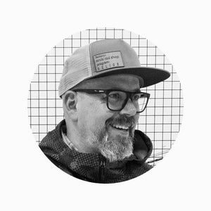 a black and white headshot of Orvis Director of Design & Development, Shawn Combs