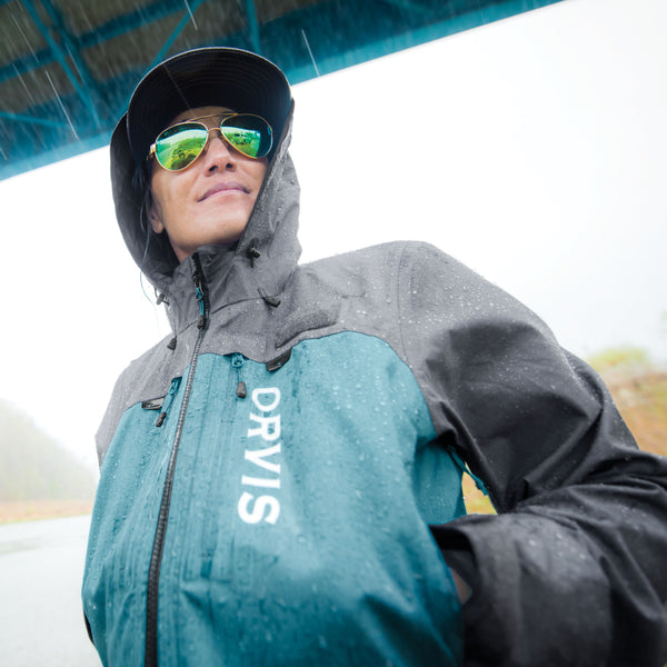 Female angler smiles in rain and sunglasses